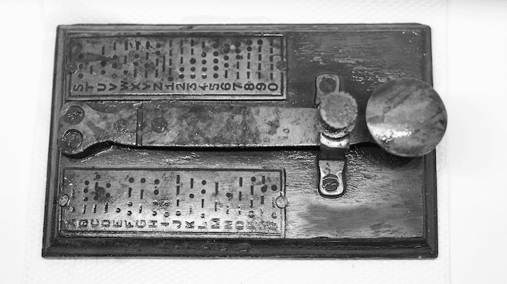 Older generation morse code device, with a decoding list | Featured Image for the ISO 42001 Certifications service landing page.