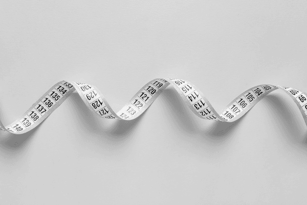 Fabric measuring tape, in a spiral across the image horizontally