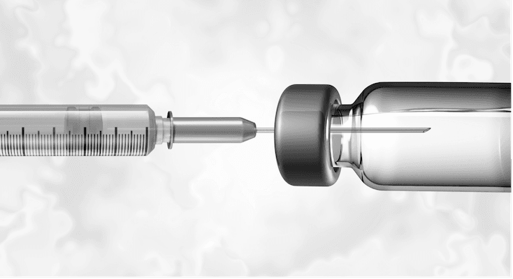 Needle going into a vial of medicine