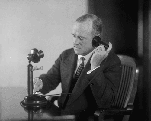 A man using a phone from the 1890s