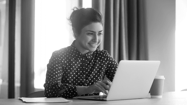 Woman smiling at laptop