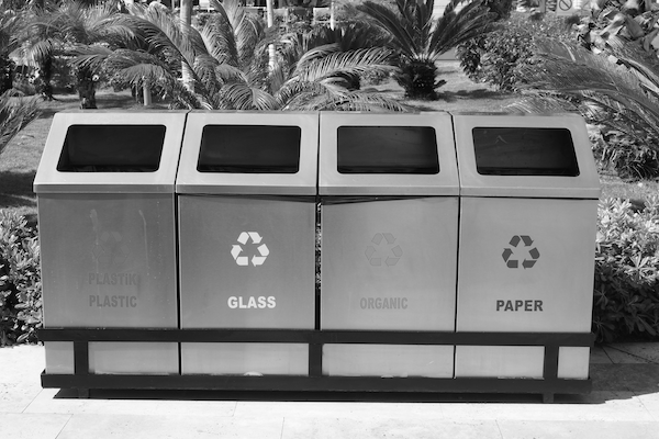 Four types of recycling bins lined up together to form one big bin for recycling