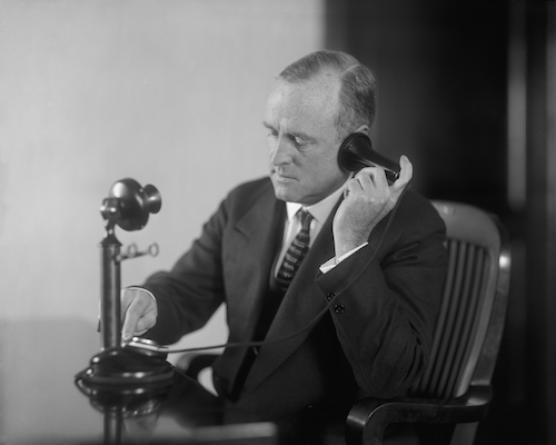 A man using a phone from the 1890s