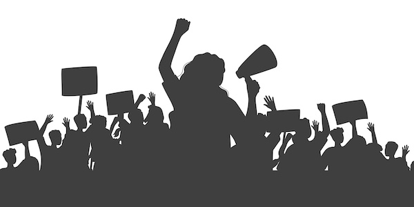 People holding signs with their arms up in the air - in grayscale